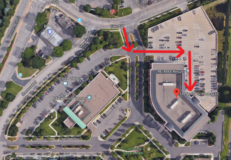 Aerial view of parking lot with red arrows indicating a driving route.